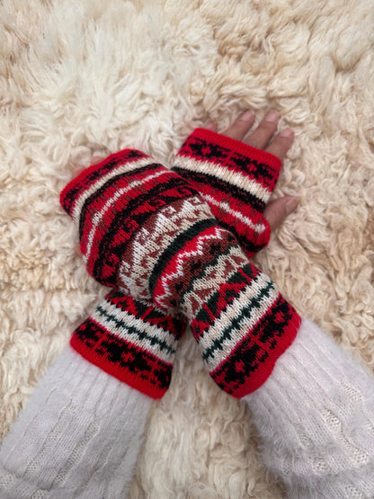 Peruvian Striped Alpaca Fingerless Gloves worn on hands resting on a sheepskin rug