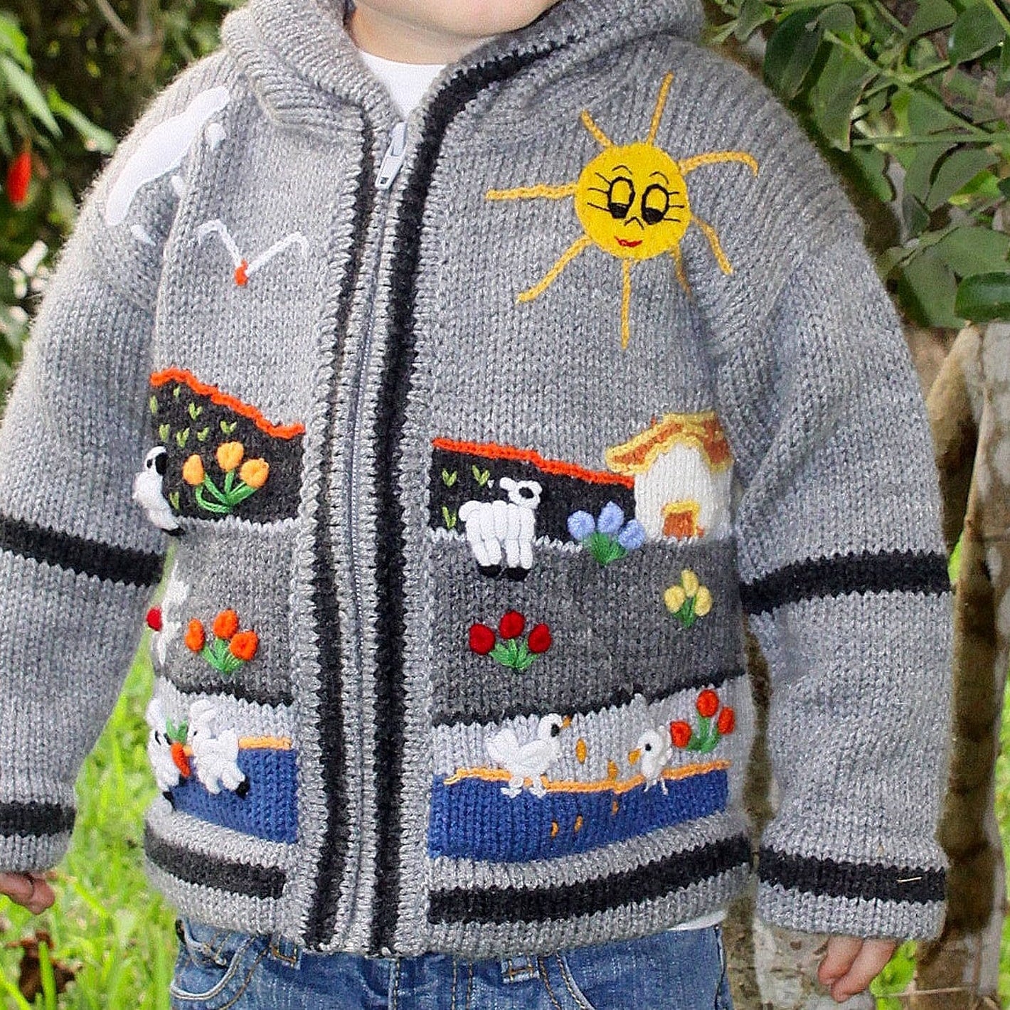 Grey children's alpaca cardigan hand-embroidered with a smiling sun, sheep and flowers